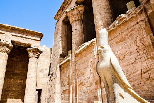 Explore the stunning ruins of an ancient Egyptian temple featuring iconic columns and a falcon statue.