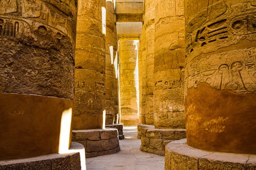 Sunlit ancient columns in the historic Karnak Temple Complex in Luxor, Egypt.