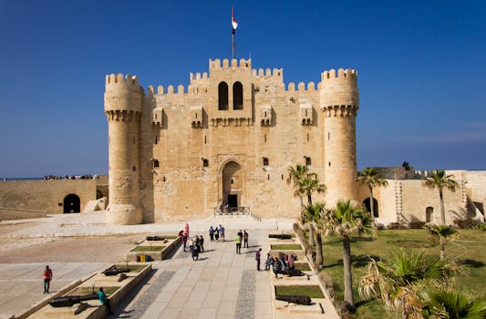 Majestic view of the historic Citadel of Qaitbay in Alexandria, Egypt against a clear blue sky.