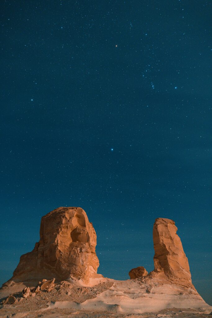 Explore the mesmerizing starry sky over desert rock formations in Siwa, Egypt.