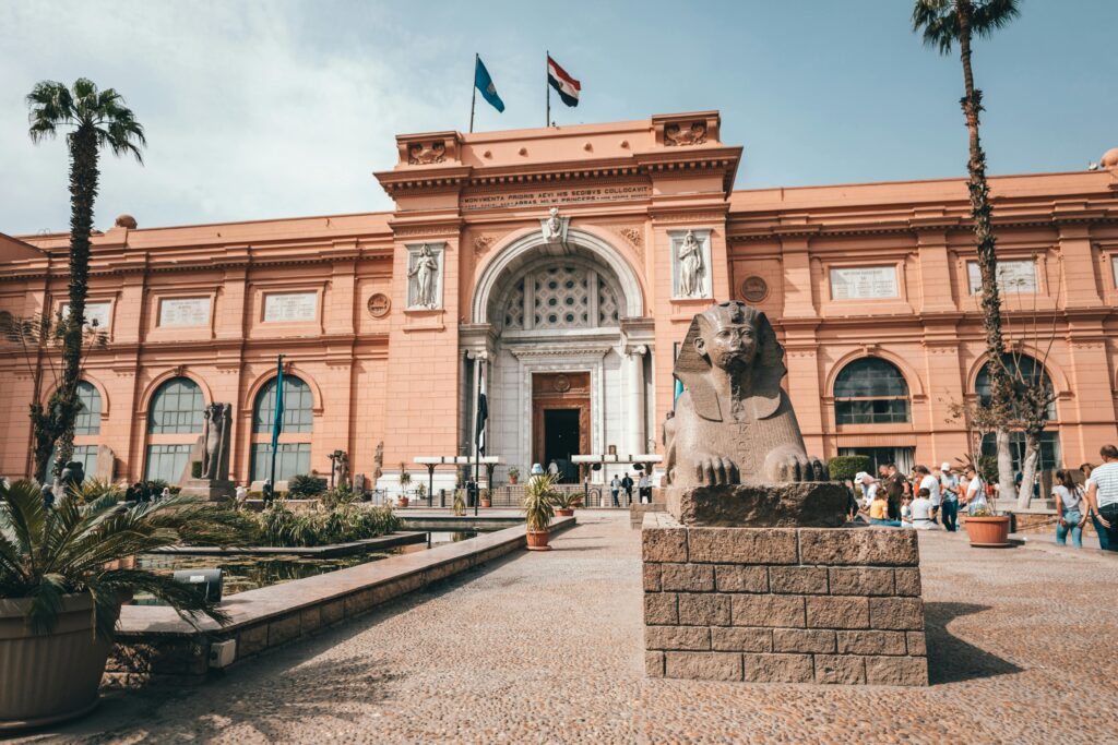 Explore the historic facade of the Egyptian Museum with its iconic sphinx statue.