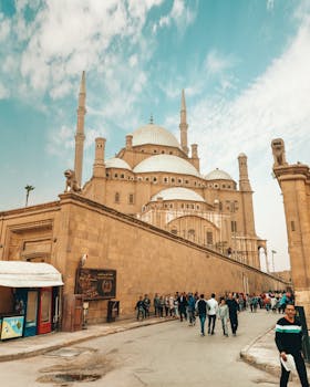 A bustling scene at the historic Mosque of Muhammad Ali in Cairo, Egypt.