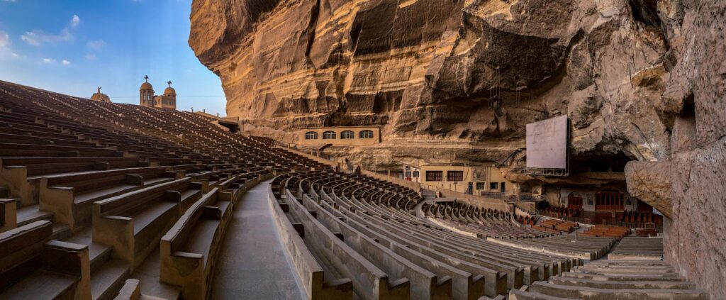 Panoramic view of St. Simon the Tanner Monastery's cave church seating area in Cairo, Egypt.