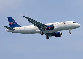 Air Cairo Airbus A320 flying against a blue sky, showcasing the airline's logo and design.