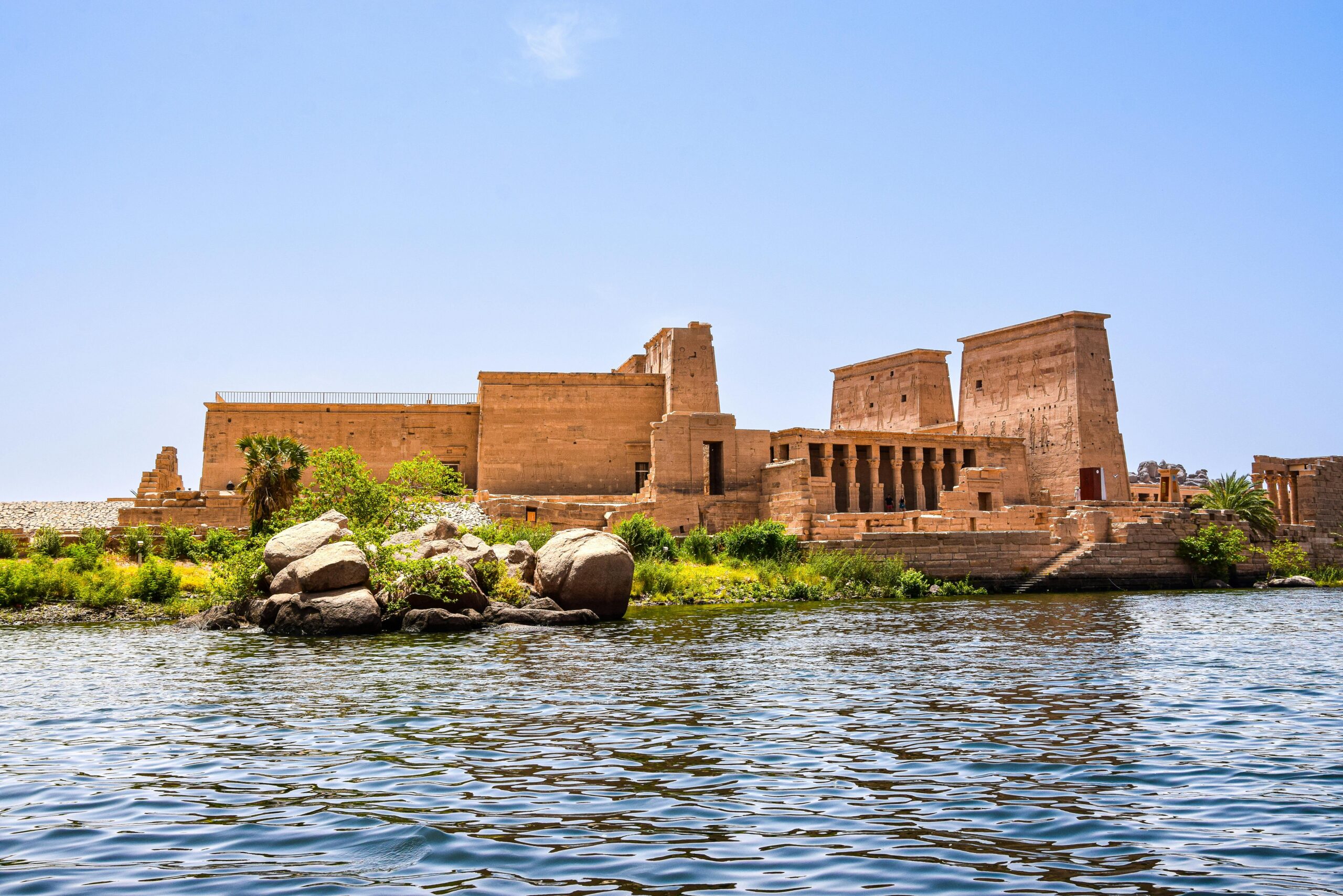 Scenic view of Philae Temple on the Nile River, showcasing ancient Egyptian architecture.