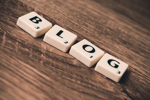 Scrabble tiles spelling 'BLOG' on a wooden background, symbolizing creativity and writing.